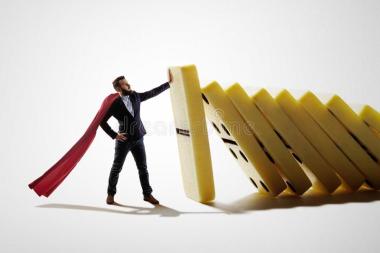man-stops-falling-dominoes-concept-crisis-management-concept-crisis-management-114570856